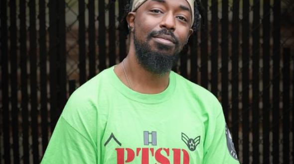Man in green shirt smiling at camera