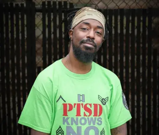 Man in green shirt smiling at camera