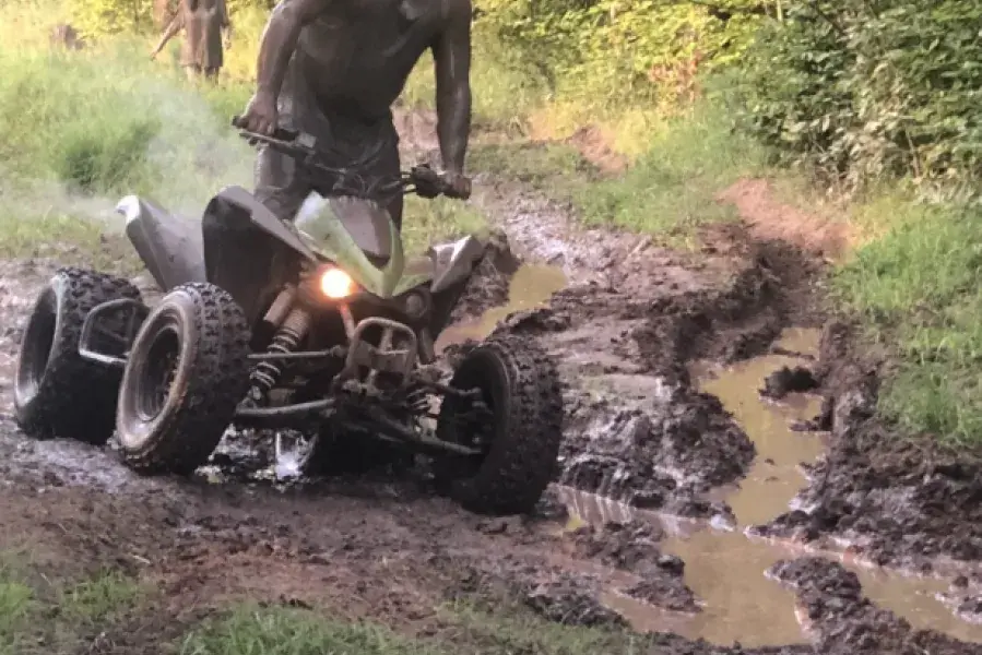 Man on fourwheeler in mud