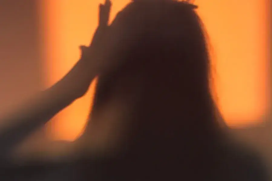 Woman outline putting on a crown